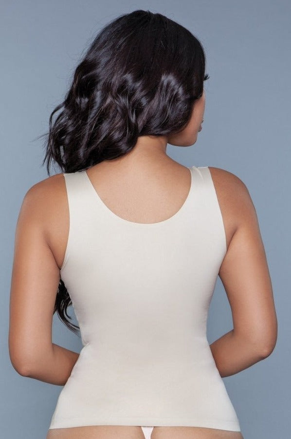 Smoothing and waist-sculpting tank top in nude, featuring wide straps and low scoop neckline for versatile layering.