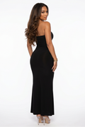 Woman wearing a black strapless gown on a white background