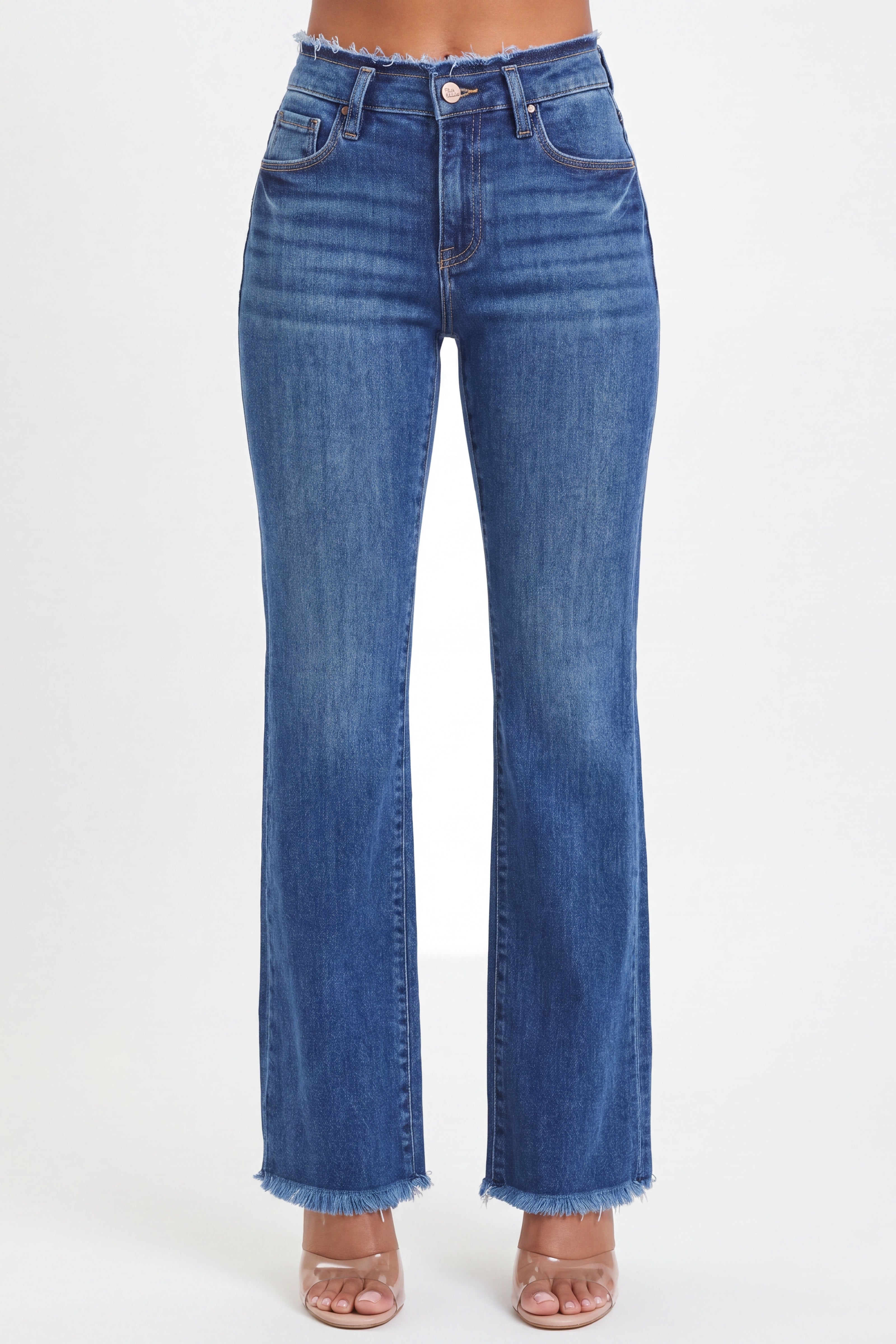 A person wearing medium-wash blue denim jeans with a frayed hem, shown from the waist down against a plain light background.