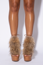 Faux fur trim stiletto sandals with a tan platform, showcasing an open toe and adjustable lace-up ankle ties.