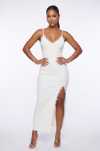 A woman modeling a fitted white spaghetti-strap maxi dress with a thigh-high slit, shown in three studio poses against a light gray background.